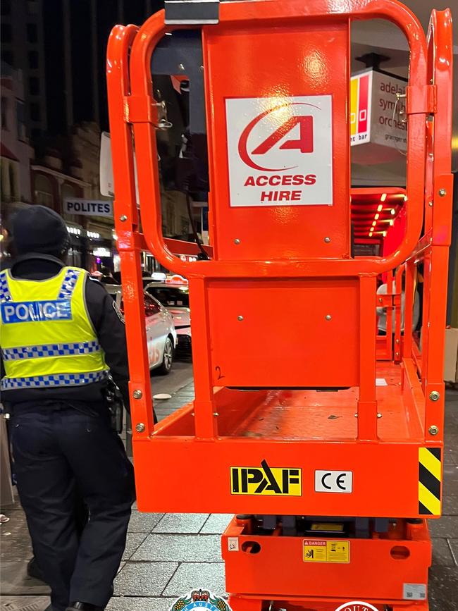 Police have arrested a man after he was caught driving a stolen scissor lift down Hindley St on Sunday morning. Picture: SAPOL