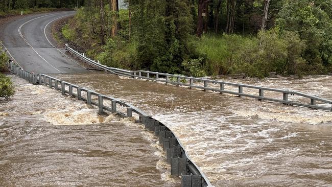 Kiamba Road, between Nambour and Yandina, is cut by flooding after heavy rain on the Sunshine Coast. Picture: Mark Furler