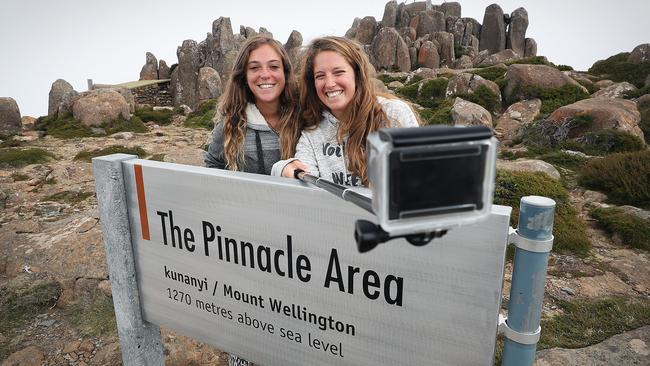 Chilean tourists Maria French Davis, 26, left, and Marcela Martinez, 28, grab a selfie at the summit of Mount Wellington. Picture: SAM ROSEWARNE