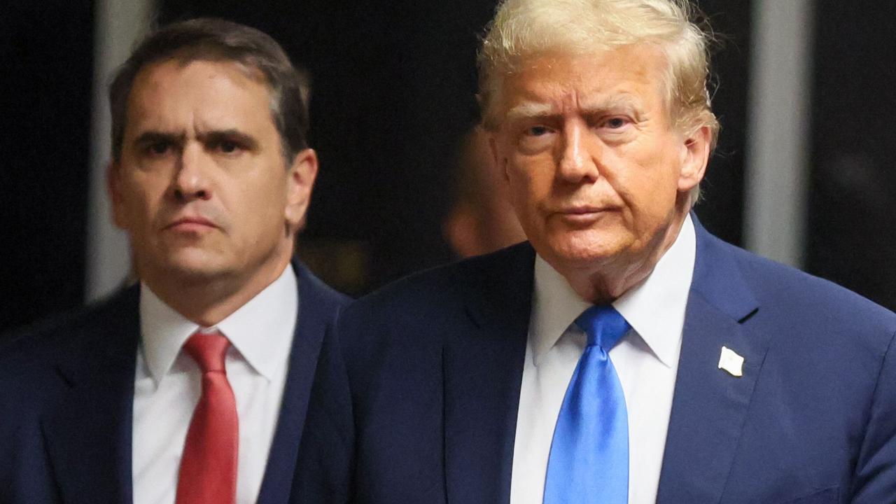 Former US president and Republican presidential candidate Donald Trump, flanked by lawyer Todd Blanche (L) arrives at Manhattan Criminal Court. (Photo by Brendan McDermid / POOL / AFP)