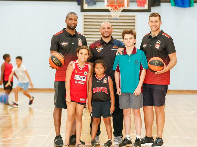 Cortez Groves (Illawarra Hawks), Joel Khalu (Indigenous Pathways Manager – Queensland North) and Tyson Demos (Hawks) ran some junior basketball clinics in Darwin in 2019. Picture: Glenn Campbell