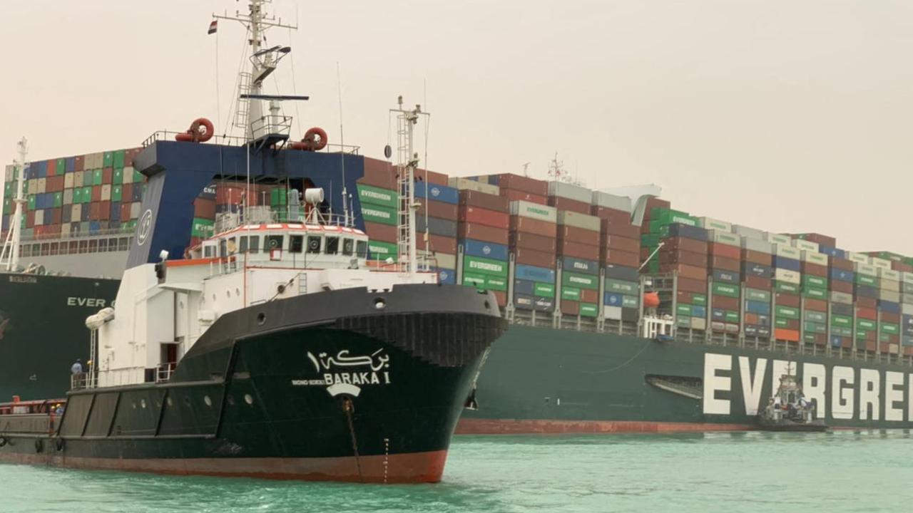 Taiwan-owned MV Ever Given (with tug boat in the foreground), a 400m ship lodged sideways. Picture: Suez Canal/AFP