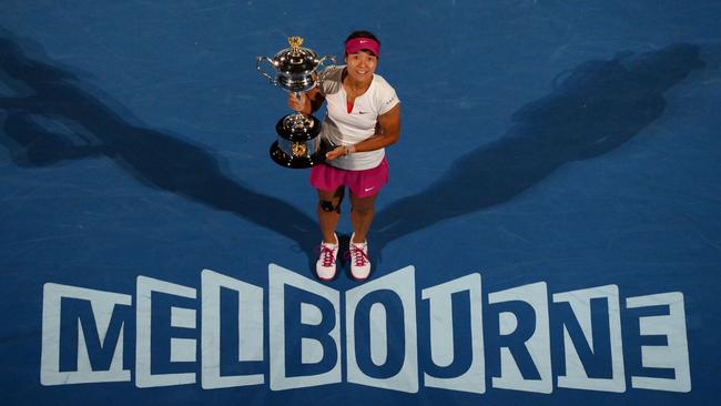 Li Na of China poses with the trophy after winning the Australian Open women's singles final in 2014. picture: William West/AFP