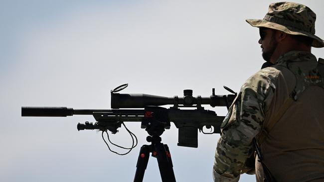 A sharpshooter looks on before US President and Republican presidential candidate Donald Trump speaks at the campaign rally.