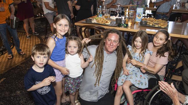 Joel Anderson with his nieces and nephews (from left) Connor Hinrichsen, Ivy Ferguson, Remi Ferguson, Ava Hinrichsen as his dreadlocks are cut off in a fundraiser for his daughter Charlise Anderson (right) at the Blue Mountain Hotel, Saturday, November 23, 2024. Picture: Kevin Farmer