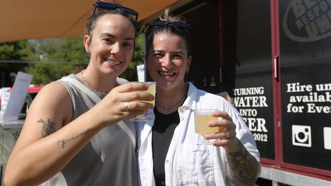 Lauren Riley and Mel Gunn drinking laksa seltzers from One Mile Brewing Company at the 2024 Darwin International Laksa Festival on Sunday, November 3. Picture: Zizi Averill