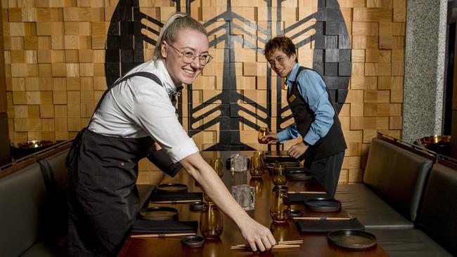 The Star Gold Coast workers Emily Berry and Matthew Tran preparing tables when restaurants reopened in June. Picture: Jerad Williams