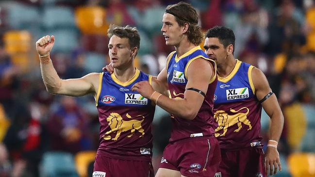 Lincoln McCarthy celebrates a goal with teammates Jarrod Berry and Charlie Cameron. Picture: Jono Searle/AFL Photos/via Getty Images