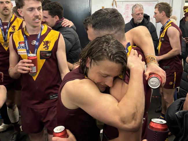 Rogers (L) hugs teammate Cory Hargraves.