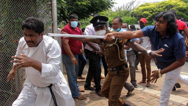 Demonstrators and government supporters clash outside the President's office in Colombo on Monday. Picture: AFP