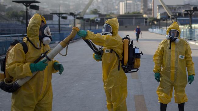 Health workers get ready to spray insecticide to combat the mosquitoes that transmit the Zika virus.