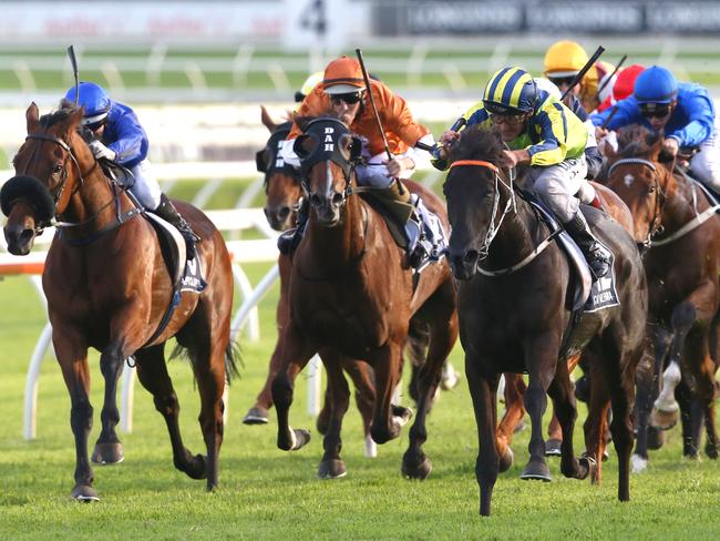 Damien Oliver and Lucia Valentina (second right) storm to the front. Picture: AAP