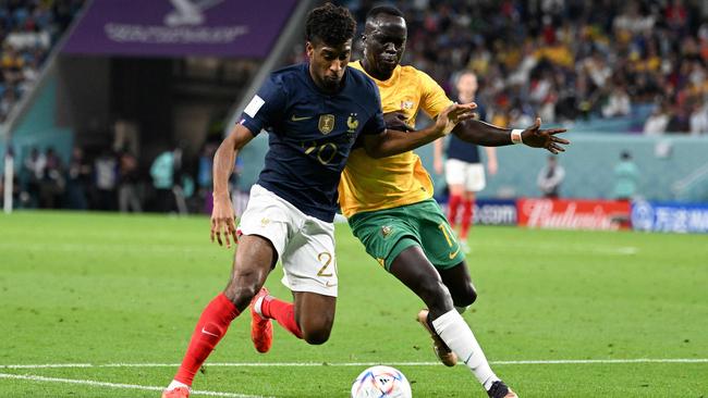 Awer Mabil fights for the ball with France's Kingsley Coman. Picture: Chandan KHANNA/AFP