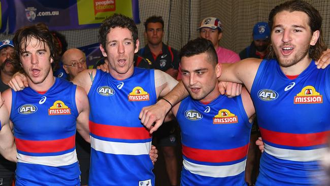 Liam Picken, Bob Murphy, Luke Dahlhaus and Marcus Bontempelli sing the song after a win.