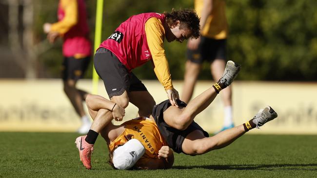 Hawthorn forwards Nick Watson (standing) and Jack Ginnivan wrestle at Waverley Park on Tuesday. Picture: Darrian Traynor / Getty Images