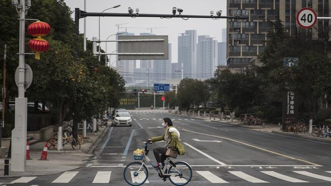 A lone cyclist in the empty streets of Wuhan. Picture: Getty Images.