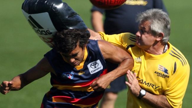 Coach Neil Craig belts young Tony Armstrong with a bag.