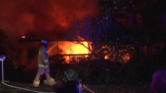 Flames tear through the top floor of the two-storey house in Dublin Ave, Killarney Heights, just minutes after the elderly couple were rescued. Picture: TNV