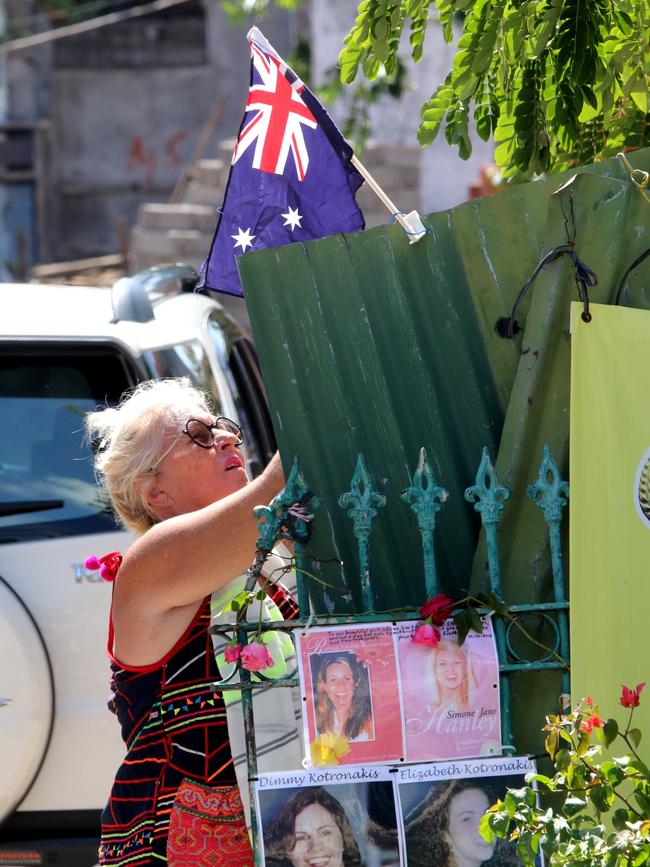 An Australian women puts the Australian flag at the site of the Sari Club during the commemoration of the Bali Bombing at The Ground Zero Monumen. Picture: Lukman S.Bintoro