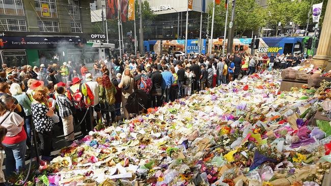 The armed man was pictured patrolling near the flower memorial in Bourke St days after the massacre, during which six people died and 37 were injured. Picture: Getty Images