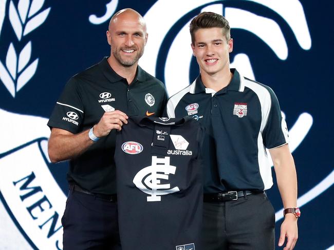 Chris Judd at work, handing draft pick Liam Stocker his jersey.