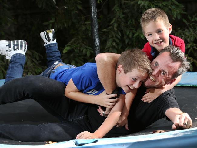 Dad Justin Phillips and his boys Luke and Toby. Picture: David Crosling