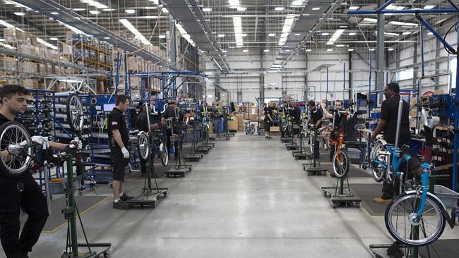 Employees assemble folding bicycles at the Brompton factory in London