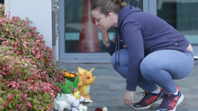 Flowers and toys are left at the scene in a car park where the 4-year-old was killed. Picture: Hamish Blair