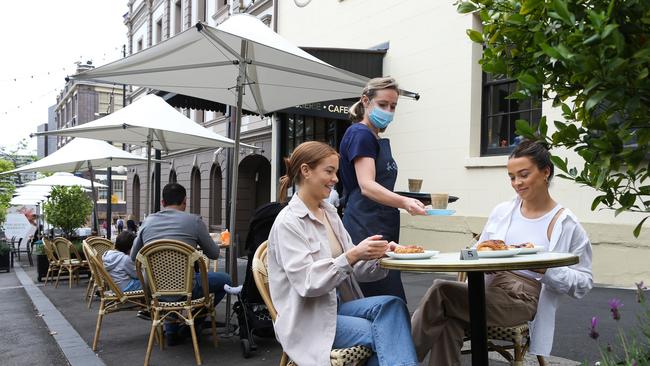 Mia Johnson and sister Eveleyn Johnson enjoying a coffee at the La Renaissance Cafe in the Rocks as the cafe opens up for outdoor dining. Picture: NCA Newswire / Gaye Gerard