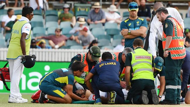 Medics and officials surround Sri Lanka's batsman Dimuth Karunaratne. Picture: AAP