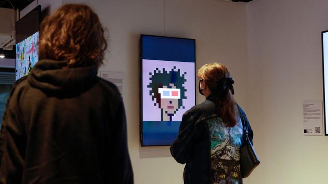 Visitors view the digital art piece "CryptoPunk #553" by Larva Labs during the opening weekend of the Seattle NFT Museum on January 29.