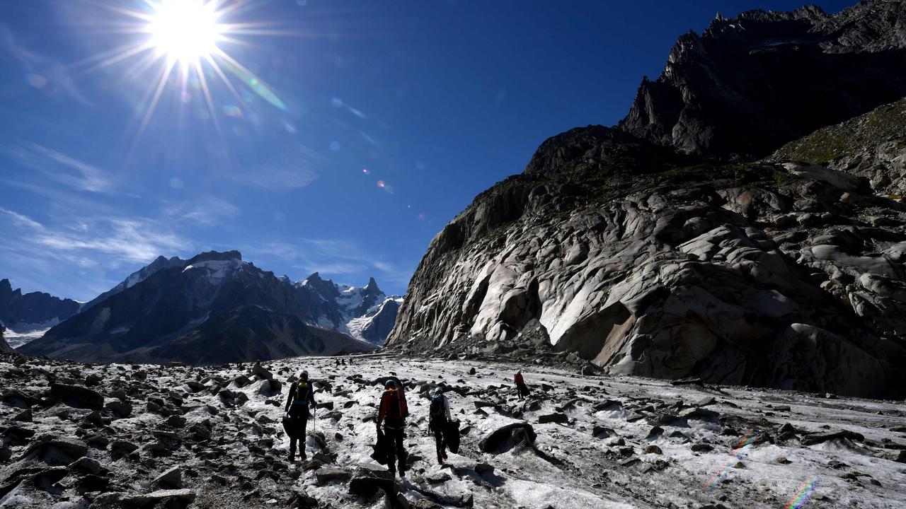 Walkers on the Mer de Glace glacier in Chamonix-Mont Blanc, French Alpes. many alpine routes are becoming too dangerous. Photo: Jean Pierre Clatot/AFP