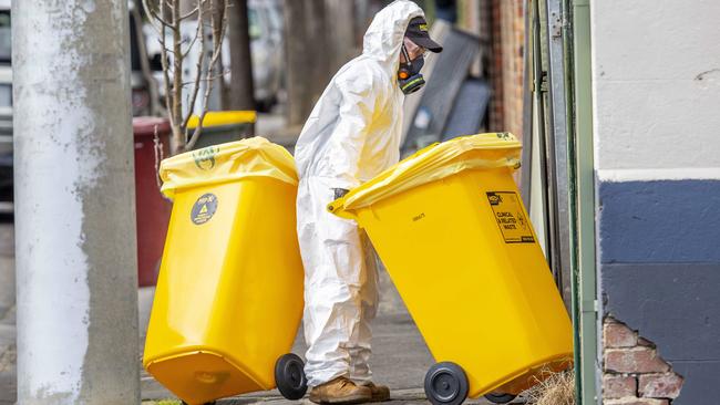 Bins are moved into the property on Sunday. Picture: Tim Carrafa