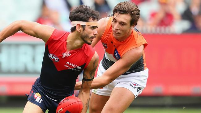 Jeff Garlett is tackled by Caleb Marchbank.