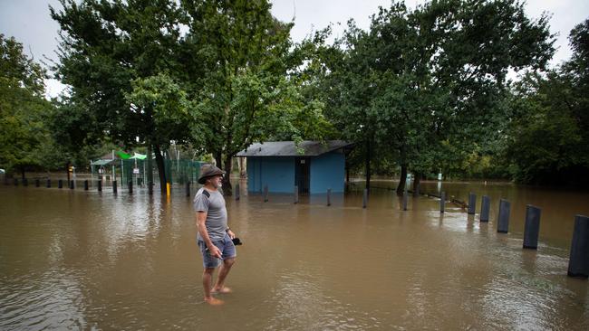 Graham Gallagher surveys the floodwaters at the end of his street. Picture: Julian Andrews