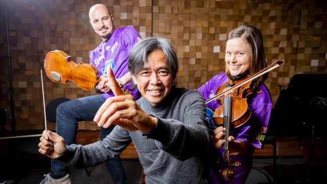 Composer and conductor Chong Lim (centre) with TSO musicians Sercon Danis and Edwina George as they prepared to perform the BBL anthem at the opening match at Blundstone Arena in 2020. Picture: Richard Jupe