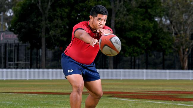 Gregory Terrace prop Ezekiel Amituanai passes the ball at training. Picture: AAP/John Gass.