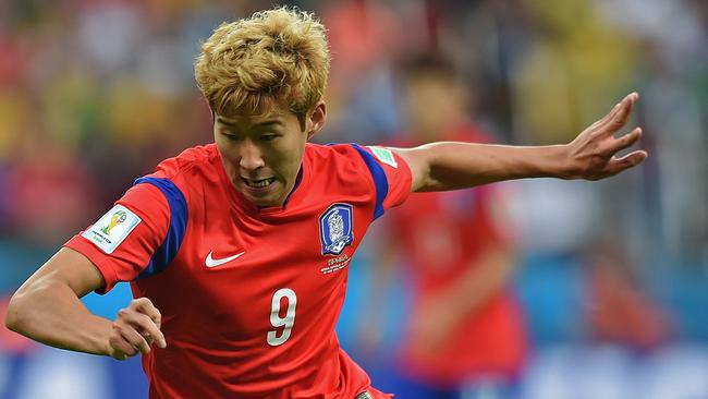 (FILES) In a file picture taken on June 22, 2014, South Korea's midfielder Son Heung-Min advances with the ball before scoring a goal during the Group H football match between South Korea and Algeria at the Beira-Rio Stadium in Porto Alegre during the 2014 FIFA World Cup. Son Heung-Min is one of the players to watch at the Asian Cup, which starts in Melbourne on January 9, 2015. AFP PHOTO / FILES / JUNG YEON-JE