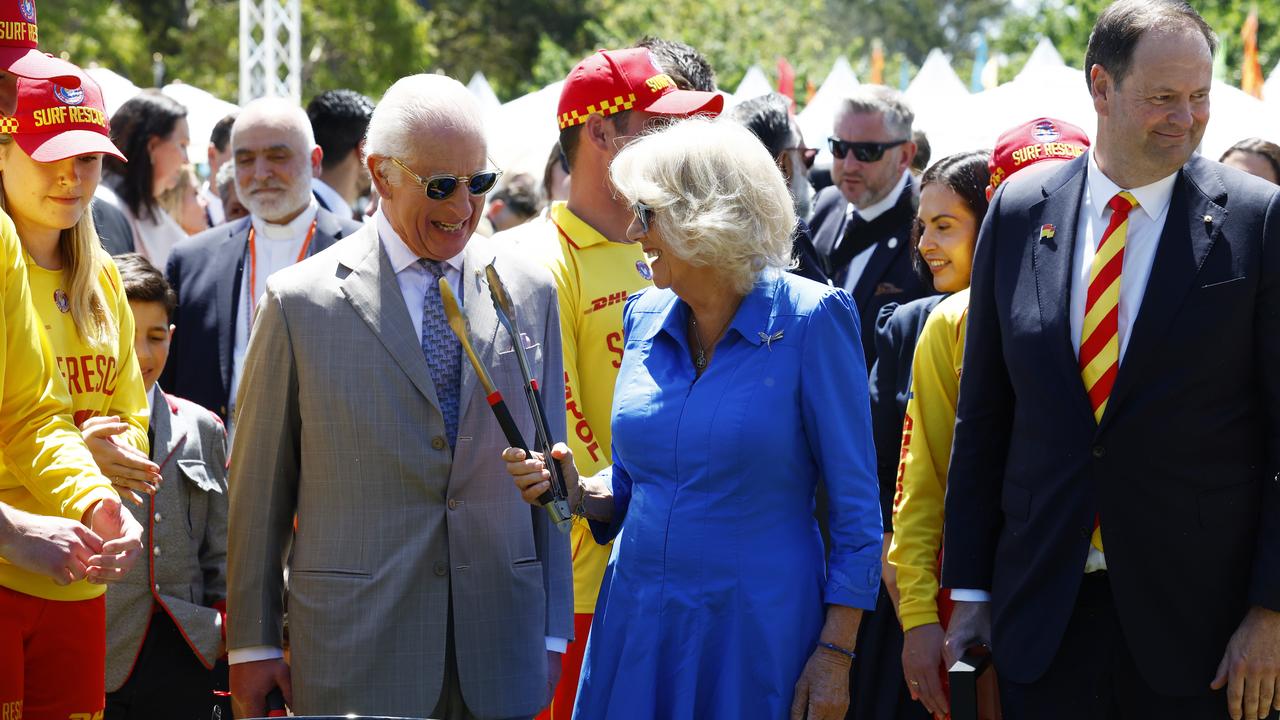 His Majesty King Charles III and Queen Camilla turn sausages at a barbecue at Parramatta Park. Picture: Jonathan Ng