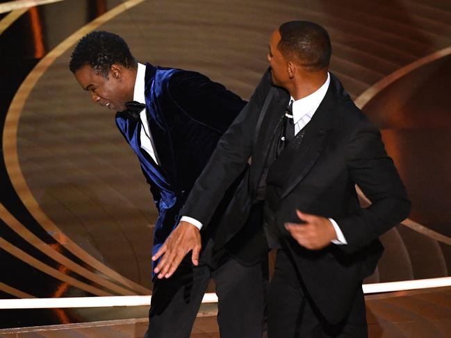 (FILES) In this file photo taken on March 27, 2022 US actor Will Smith (R) slaps US actor Chris Rock onstage during the 94th Oscars at the Dolby Theatre in Hollywood, California. - Possible sanctions against Will Smith for slapping Chris Rock at the Oscars last month will be discussed on April 8, 2022, 10 days earlier than previously scheduled, the body that oversees the awards said. (Photo by Robyn Beck / AFP)