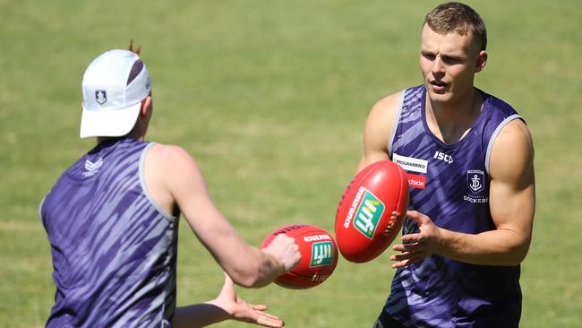 Brett Bewley handballs during a Fremantle Dockers AFL training session.