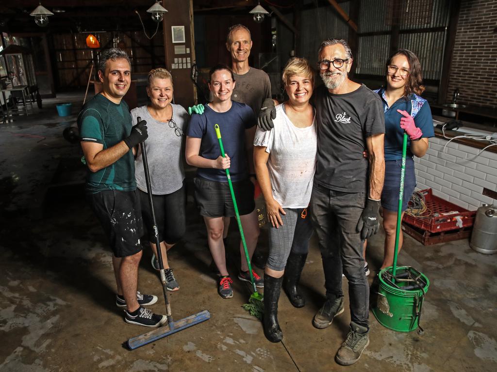 Owners of Collingwood Black and Craft'd Grounds cafe, (front) Kirstie and James Rennell alongside their clean up crew (L-R) Remy Harman, Jo Sterritt, Kimberley Bruce, Tom Metcalfe and Jacqui Erbel. Picture: Zak Simmonds