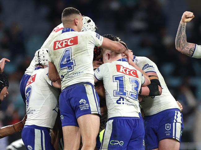 SYDNEY, AUSTRALIA - JUNE 28:  Matt Burton of the Bulldogs celebrates with team mates after kicking a golden point field goal in extra time to win the round 17 NRL match between Canterbury Bulldogs and Cronulla Sharks at Accor Stadium on June 28, 2024, in Sydney, Australia. (Photo by Cameron Spencer/Getty Images)