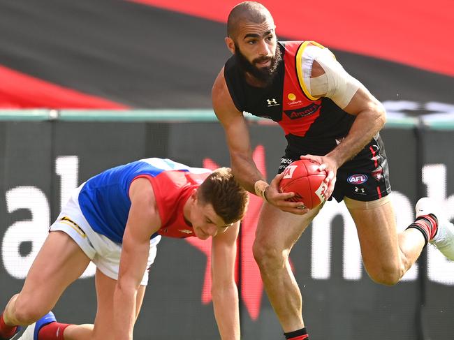 GOLD COAST, AUSTRALIA - SEPTEMBER 19: Adam Saad of the Bombers kicks during the round 18 AFL match between the Essendon Bombers and the Melbourne Demons at Metricon Stadium on September 19, 2020 in Gold Coast, Australia. (Photo by Quinn Rooney/Getty Images)