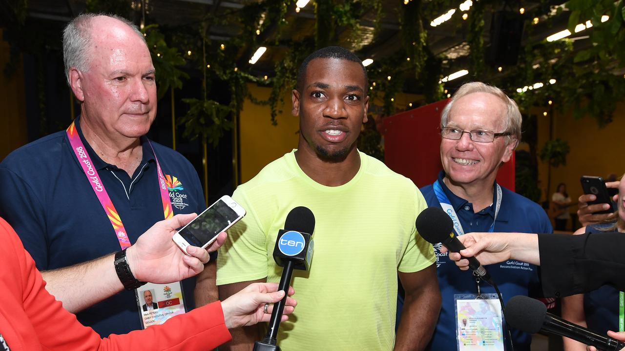 Jamaican athlete Yohan Blake (centre) is seen with Chief Executive Officer of the Gold Coast 2018 Commonwealth Games Mark Peters (left) and GOLDOC chairman Peter Beattie (right) during a media tour of the Gold Coast Commonwealth Games Athletes Village on the Gold Coast, Sunday, March 18, 2018. (AAP Image/Dave Hunt)