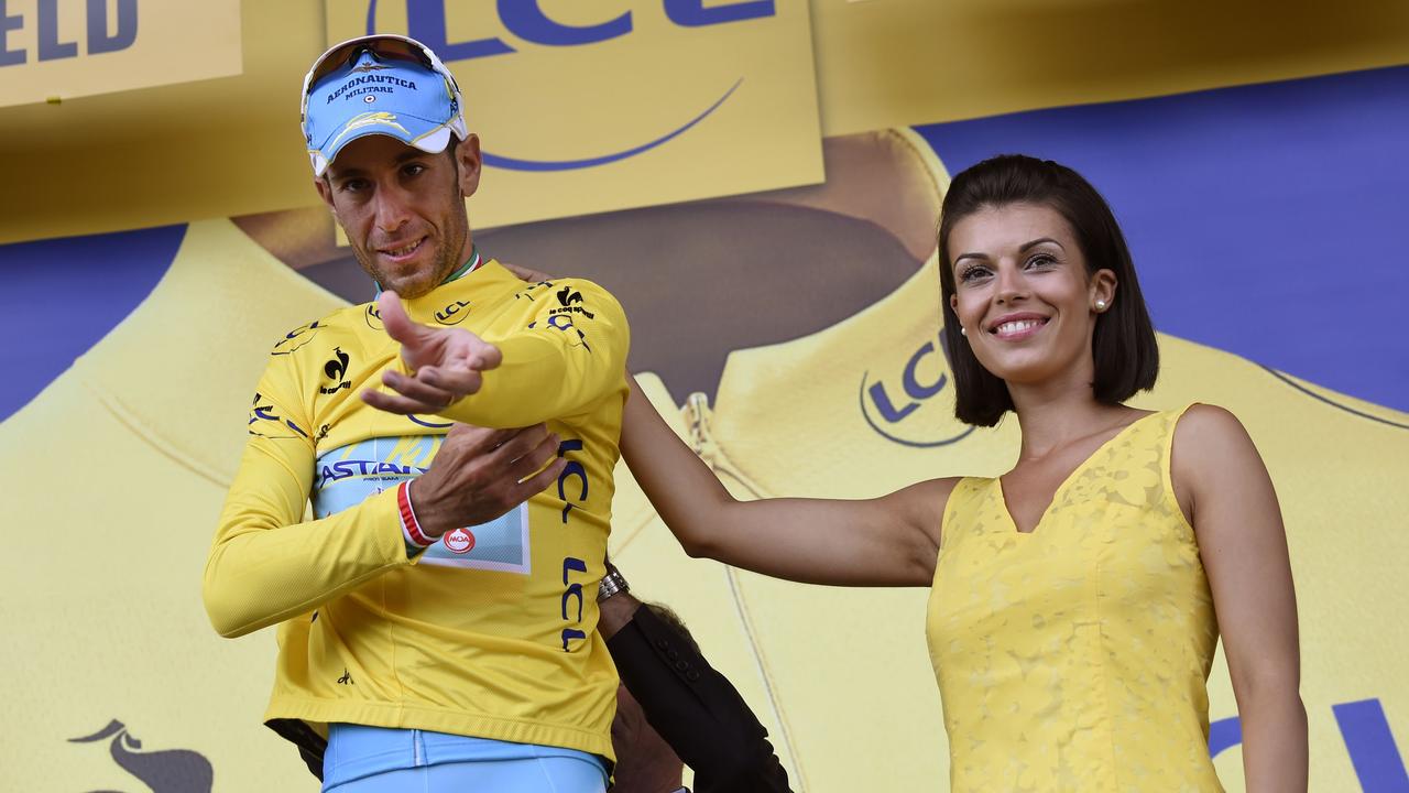 Italy's Vincenzo Nibali puts his overall leader yellow jersey on the podium at the end of the 201 km second stage of the 101th edition of the Tour de France cycling race on July 6, 2014 between York and Sheffield, northern England. AFP PHOTO / ERIC FEFERBERG