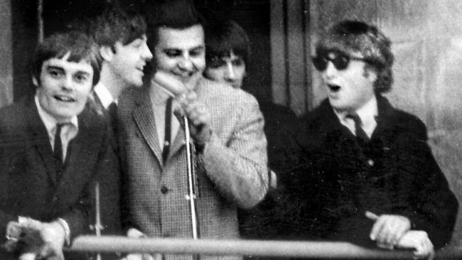 The Beatles with Bob Francis on Adelaide Town Hall’s balcony in 1964. Picture: Advertiser Library