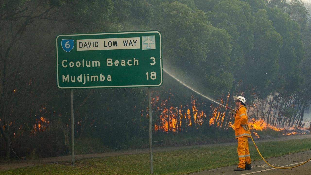 Firefighters on scene south of Peregian Beach as water bombing helicopters were called in to fight the wild bushfire. Photo Lachie Millard