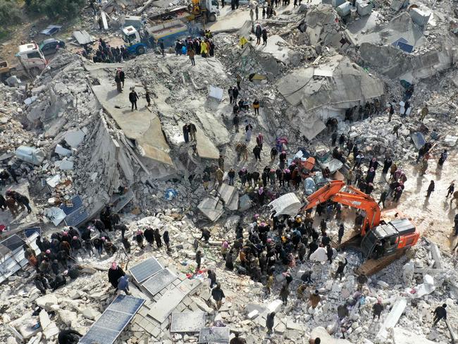 Residents, aided by heavy equipment, searching for victims and survivors amidst the rubble following an earthquake in the village of Besnia near the town of Harim, in Syria's rebel-held northwestern Idlib province. Picture: AFP