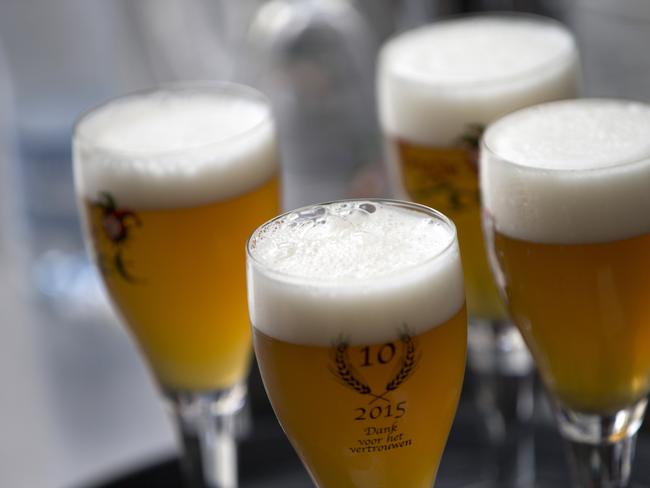 FILE - In this Thursday, May 26, 2016 file photo, glasses of beer stand on a serving tray in Bruges, Belgium. A university research survey has found that alcohol consumption in Belgium is remaining mostly stable during the country's coronavirus lockdown. A team of researchers at the University of Louvain said Wednesday, April 29,2020 that only one out of four respondents in their online survey this month reported drinking more while confined at home. (AP Photo/Virginia Mayo, File)